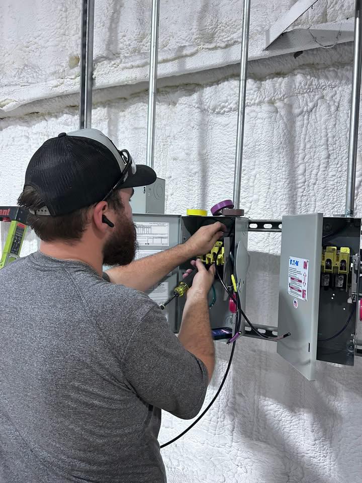 Keith Electric Company electrician working on an electrical panel